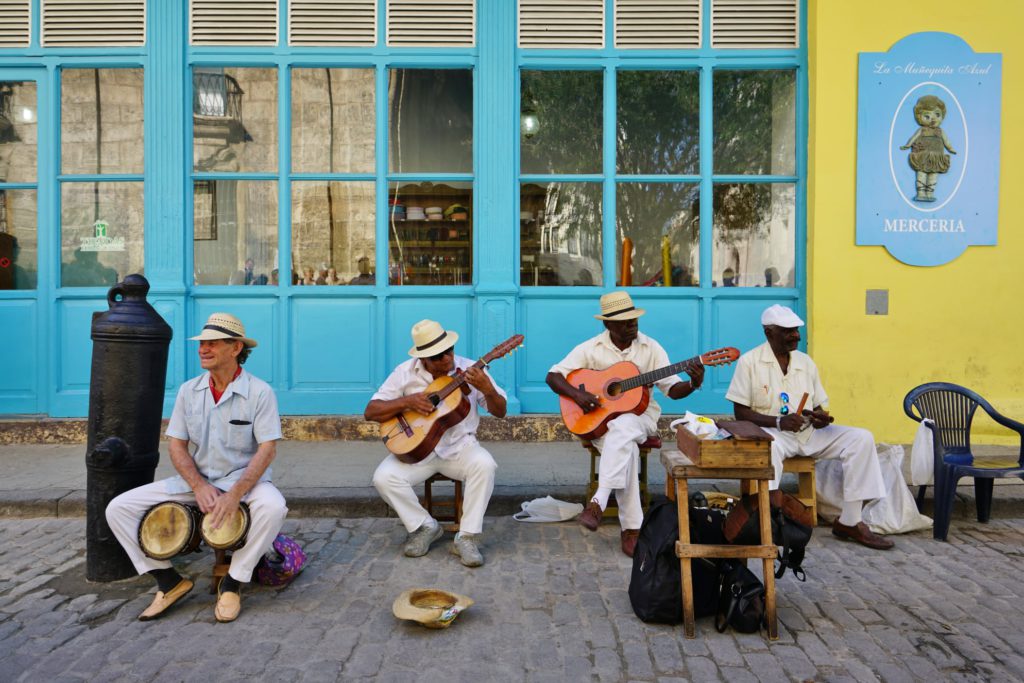 Older musicians with hats playing traditional Cuban music in Havana, the capital of Cuba.