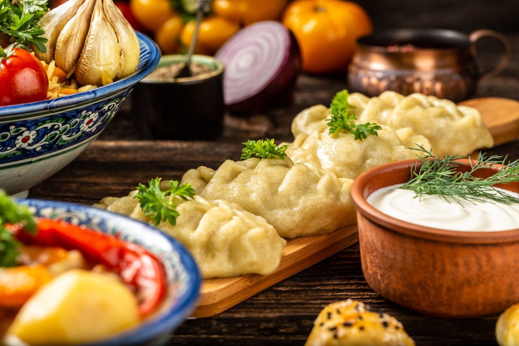 Uzbek prepared boiled Manti or manty dumplings in a traditional bowl 