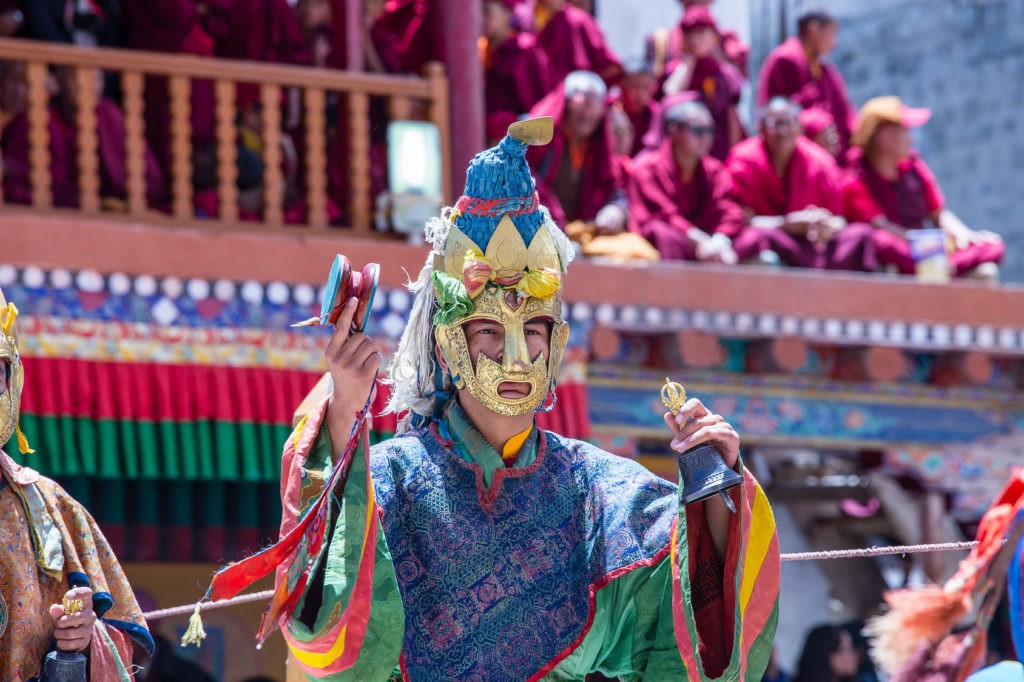 Tibetan man, dressed in a mystical mask, perform a dance during the Buddhist festival in Hemis monastery