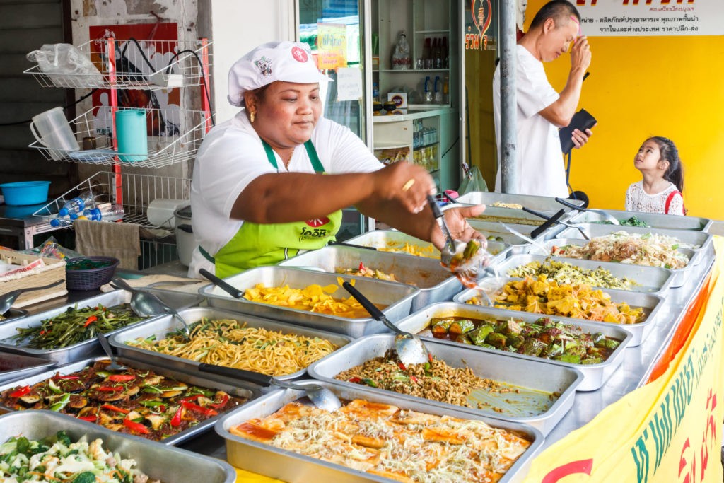 Woman serving food during the vegetarian festival. The festival is an annual event.