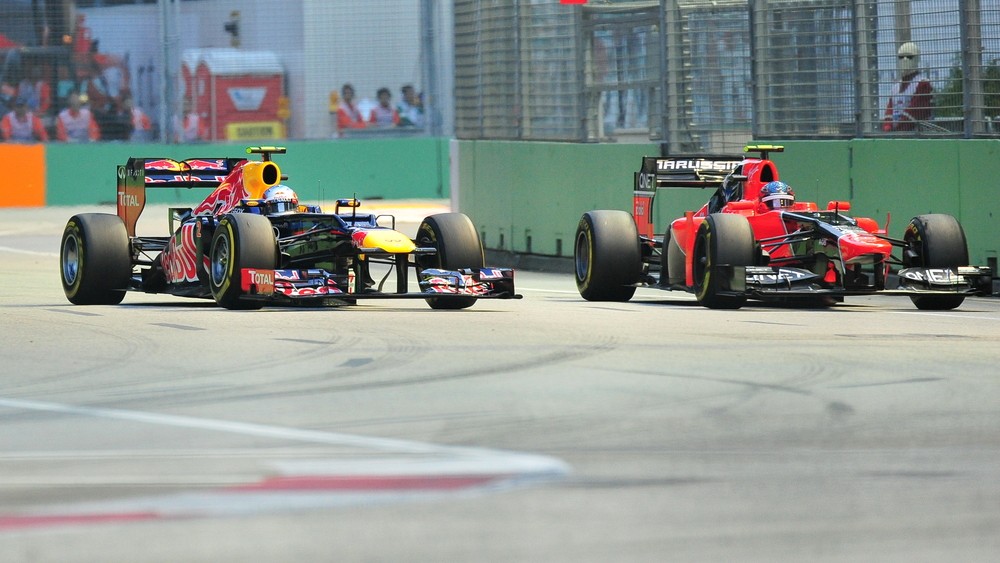 Mark Webber overtaking Charles Pic during 2012 Formula 1 Singtel Singapore Grand Prix on September 22, 2012 in Singapore