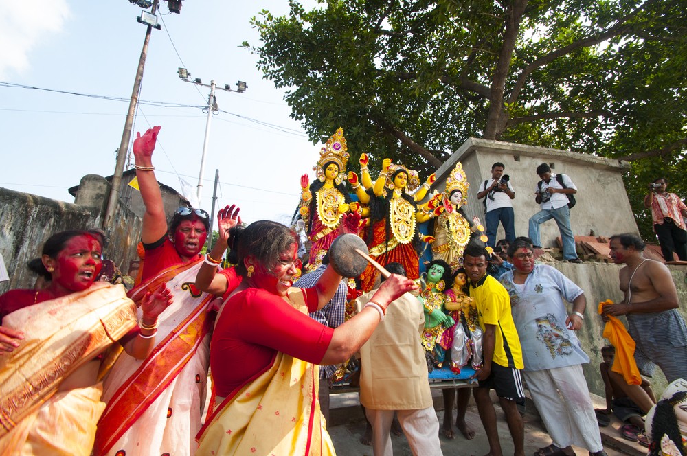 Women devotees dancing in-front of Durga idol before immersing