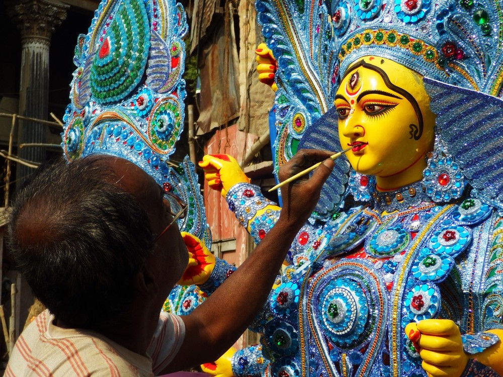 Indian craftsman painting God's statues at Kumartuli district of Kolkata, West Bengal, India
