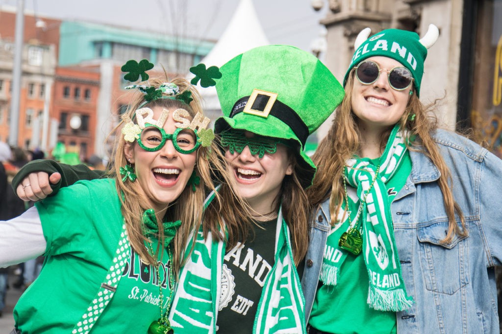 St. Patrick's Day, people with green hats and irish flags in Dublin city