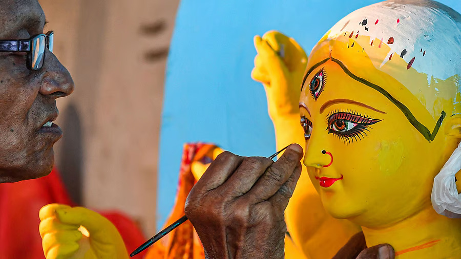 An artist gives finishing touches to an idol of Goddess Durga ahead of the Durga Puja festival, at Kumartuli in Kolkata.Credit: PTI File Photo
An artist gives finishing touches to an idol of Goddess Durga ahead of the Durga Puja festival, at Kumartuli in Kolkata